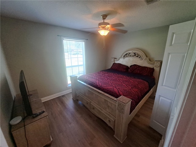 1002 Baltimore Ave, Waycross, GA 31501 - bedroom with dark wood-style floors, a textured ceiling, baseboards, and a ceiling fan