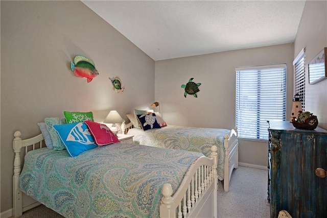 874 Wimbledon Dr, Saint Simons Island, GA 31522 - carpeted bedroom with baseboards, multiple windows, and lofted ceiling