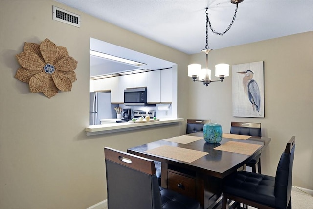 874 Wimbledon Dr, Saint Simons Island, GA 31522 - dining space with a chandelier and baseboards