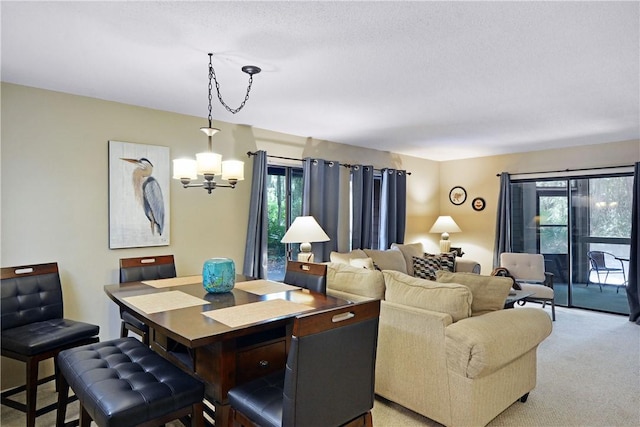 874 Wimbledon Dr, Saint Simons Island, GA 31522 - dining space with a chandelier, light carpet, and a textured ceiling