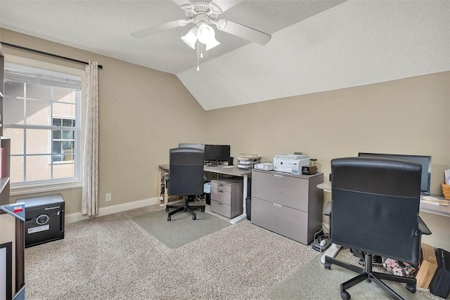 office space featuring a textured ceiling, a ceiling fan, baseboards, vaulted ceiling, and carpet