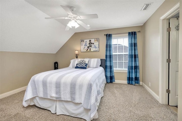 carpeted bedroom with vaulted ceiling, ceiling fan, visible vents, and baseboards