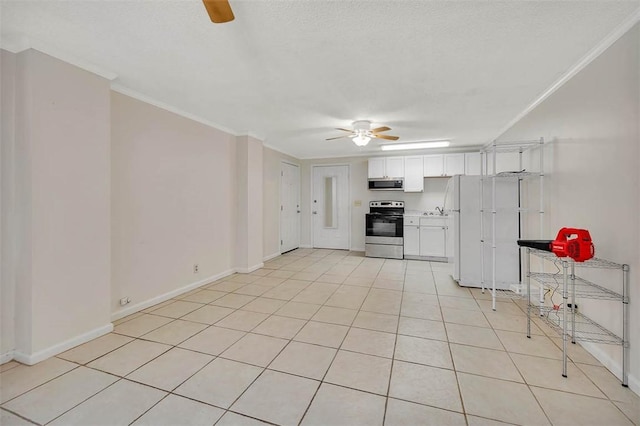 239 Georgia St, Saint Simons Island, GA 31522 - kitchen with appliances with stainless steel finishes, ceiling fan, white cabinetry, crown molding, and light tile patterned floors