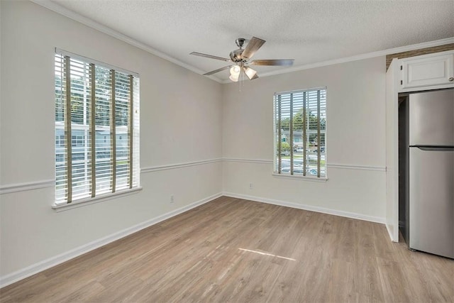 239 Georgia St, Saint Simons Island, GA 31522 - unfurnished dining area with a ceiling fan, ornamental molding, a textured ceiling, and light wood-type flooring