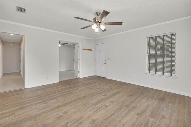239 Georgia St, Saint Simons Island, GA 31522 - spare room with attic access, ceiling fan, wood finished floors, a textured ceiling, and crown molding