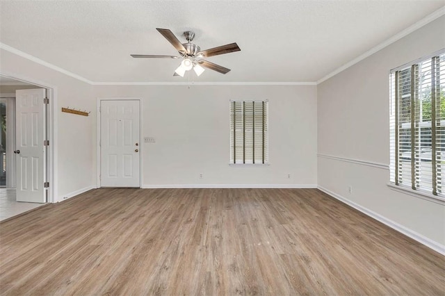239 Georgia St, Saint Simons Island, GA 31522 - unfurnished room featuring light wood-type flooring, a ceiling fan, and ornamental molding
