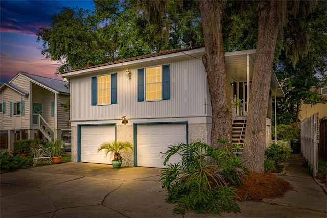 239 Georgia St, Saint Simons Island, GA 31522 - view of front of home featuring stairway, a garage, and concrete driveway