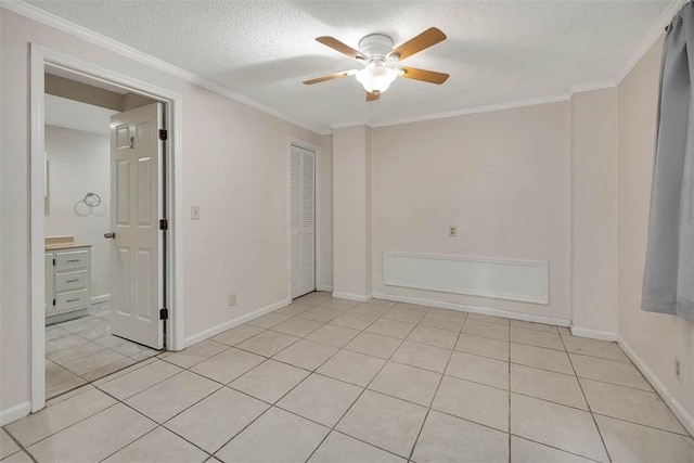 239 Georgia St, Saint Simons Island, GA 31522 - empty room with ceiling fan, crown molding, a textured ceiling, and light tile patterned floors
