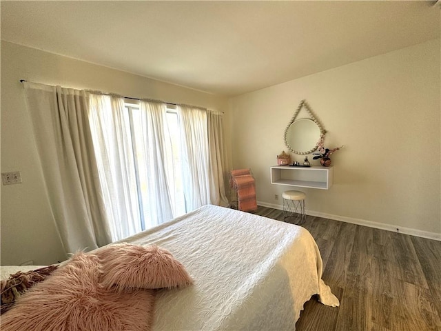 bedroom with dark wood-type flooring