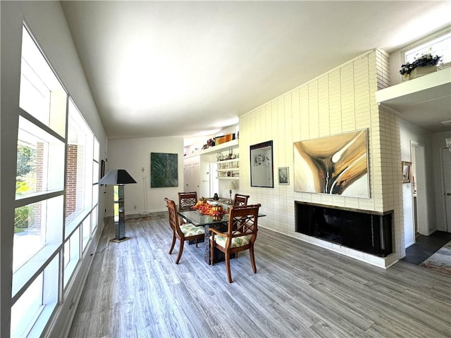 dining area featuring hardwood / wood-style flooring and lofted ceiling