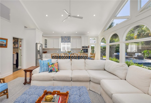 122 Saint Andrews Dr, Saint Simons Island, GA 31522 - living area with high vaulted ceiling, ceiling fan, light wood-type flooring, and recessed lighting