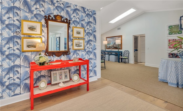 122 Saint Andrews Dr, Saint Simons Island, GA 31522 - hallway with lofted ceiling, wood finished floors, and wallpapered walls