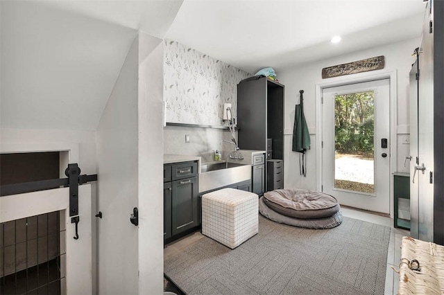 kitchen featuring tasteful backsplash, light countertops, and a sink