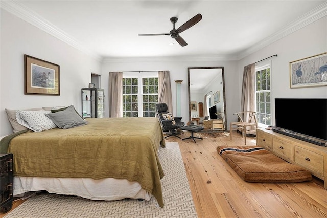 bedroom with multiple windows, a ceiling fan, wood finished floors, and crown molding