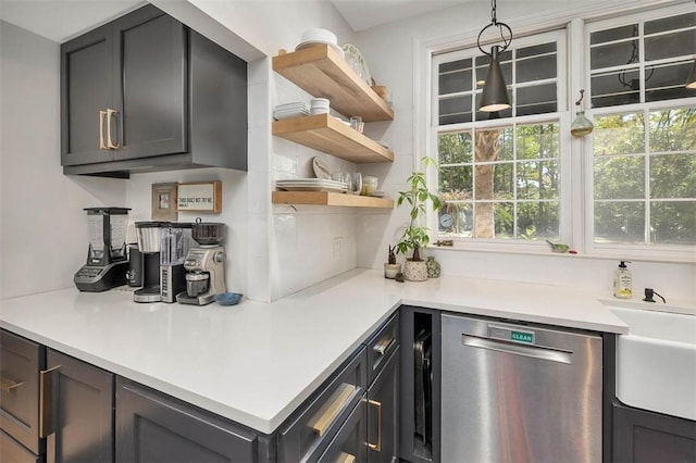 kitchen featuring dishwasher, light countertops, and plenty of natural light