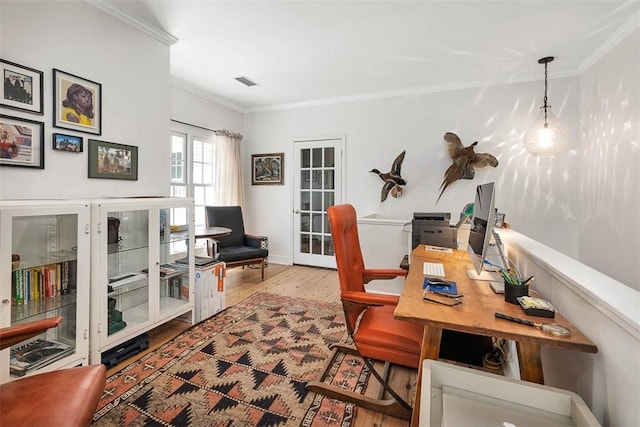 office area featuring wood finished floors, visible vents, french doors, and ornamental molding