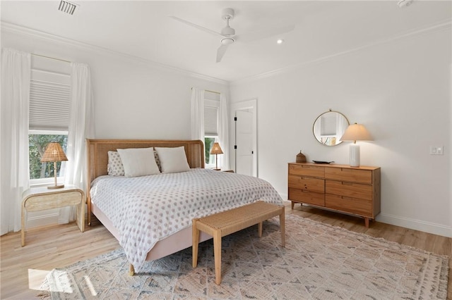 bedroom featuring crown molding, ceiling fan, and light wood-type flooring