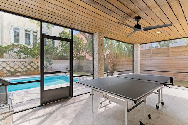 game room featuring wood ceiling and expansive windows