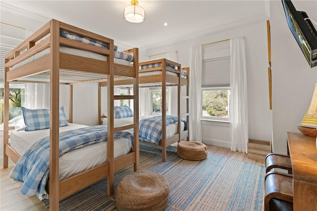 bedroom featuring wood-type flooring and ornamental molding