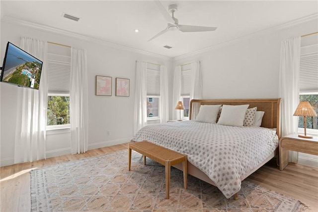 bedroom with crown molding, ceiling fan, and light wood-type flooring