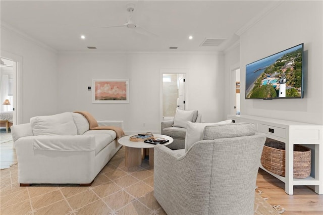 living room featuring crown molding, ceiling fan, and light hardwood / wood-style flooring