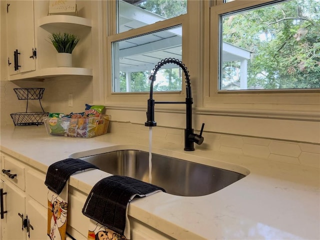 4166 Southern Rd, Brunswick, GA 31520 - kitchen view of open shelves, backsplash, light countertops, and white cabinets