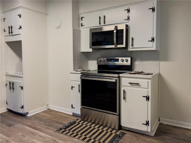 4166 Southern Rd, Brunswick, GA 31520 - kitchen featuring stainless steel appliances, wood finished floors, light countertops, backsplash, and white cabinets