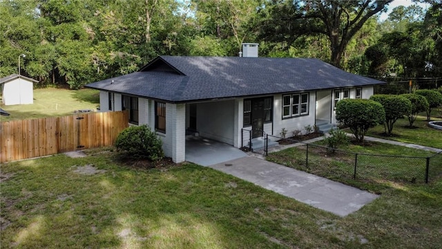 4166 Southern Rd, Brunswick, GA 31520 - single story home with concrete driveway, a carport, a shingled roof, and a chimney