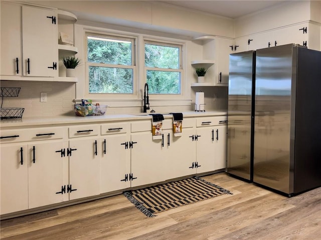 4166 Southern Rd, Brunswick, GA 31520 - kitchen featuring freestanding refrigerator, open shelves, light wood finished floors, and decorative backsplash