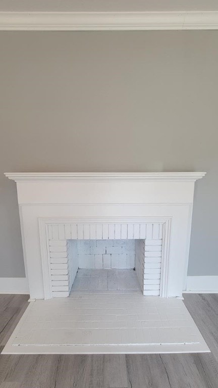 506 Ware St, Waycross, GA 31501 - detailed view of ornamental molding, wood finished floors, and a brick fireplace