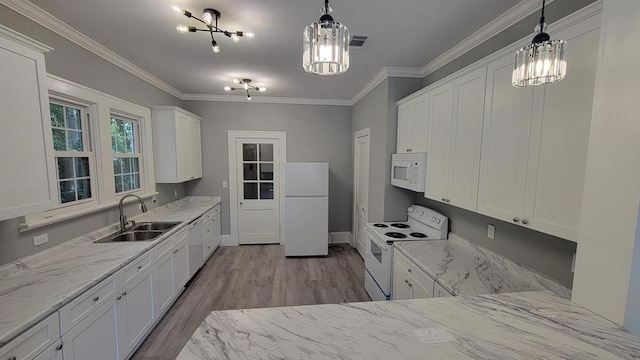 506 Ware St, Waycross, GA 31501 - kitchen featuring white appliances, wood finished floors, white cabinets, light stone counters, and crown molding