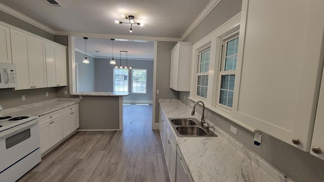 506 Ware St, Waycross, GA 31501 - kitchen with white appliances, crown molding, white cabinets, light wood finished floors, and light stone counters