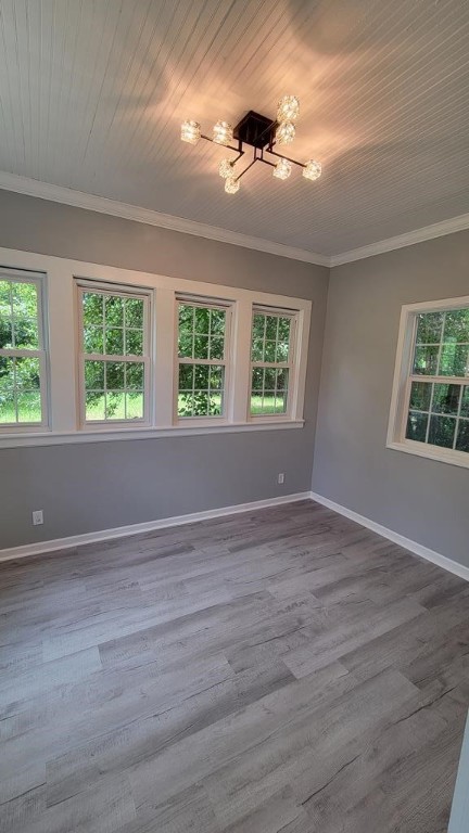 506 Ware St, Waycross, GA 31501 - unfurnished room featuring crown molding, plenty of natural light, wood finished floors, and wood ceiling