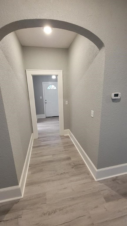 506 Ware St, Waycross, GA 31501 - corridor with arched walkways, a textured wall, and wood finished floors
