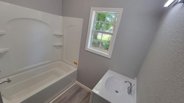 506 Ware St, Waycross, GA 31501 - bathroom featuring vanity,  shower combination, and wood finished floors