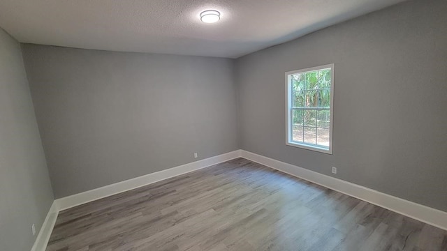 506 Ware St, Waycross, GA 31501 - unfurnished room with dark wood-style floors and a textured ceiling