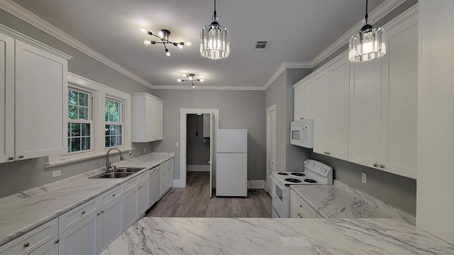 506 Ware St, Waycross, GA 31501 - kitchen featuring white appliances, white cabinets, ornamental molding, a chandelier, and decorative light fixtures