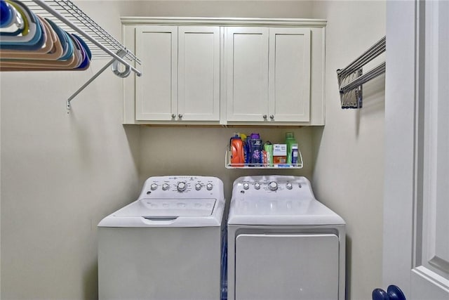 laundry room featuring cabinets and independent washer and dryer