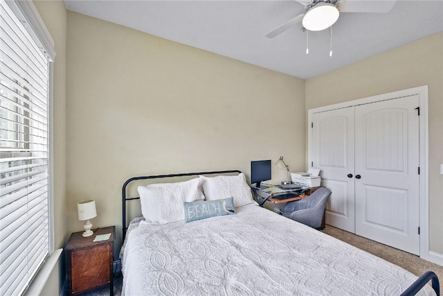 bedroom featuring ceiling fan, a closet, and carpet floors