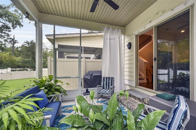 sunroom featuring ceiling fan