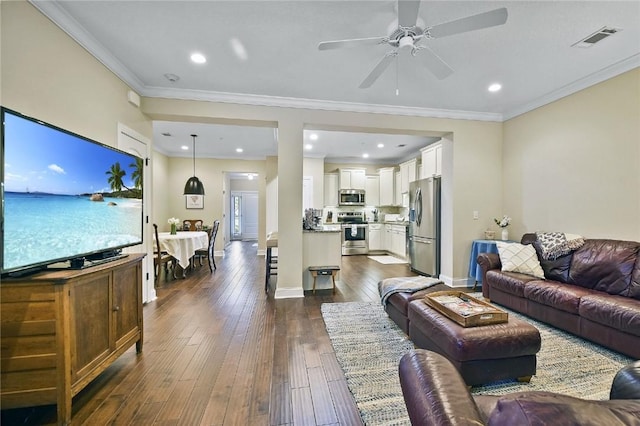 living room with crown molding, ceiling fan, and dark wood-type flooring