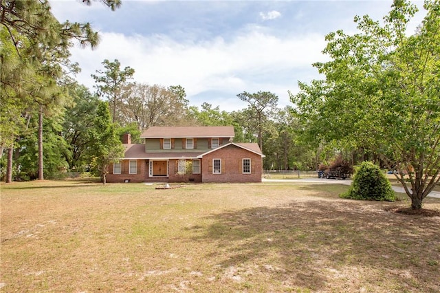 265 Traders Hill Rd, Folkston, GA 31537 - exterior space featuring brick siding, a chimney, fence, and a front yard