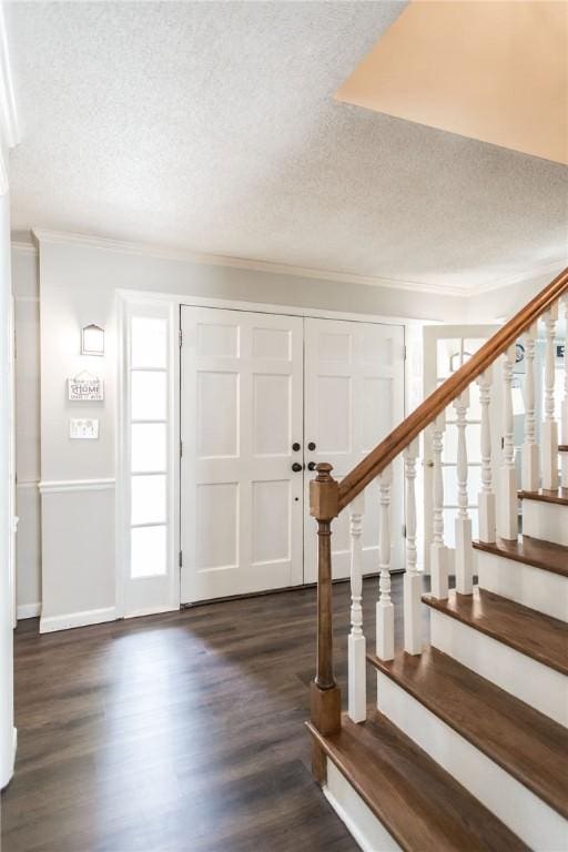 265 Traders Hill Rd, Folkston, GA 31537 - entryway featuring crown molding, a textured ceiling, dark wood-type flooring, and stairs