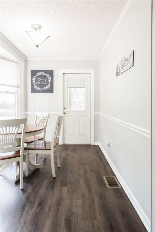 265 Traders Hill Rd, Folkston, GA 31537 - dining area with a wealth of natural light, ornamental molding, visible vents, and dark wood-style flooring