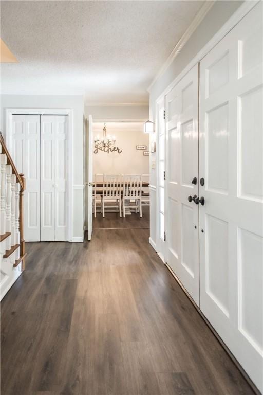 265 Traders Hill Rd, Folkston, GA 31537 - entryway with an inviting chandelier, crown molding, dark wood-type flooring, baseboards, and stairs