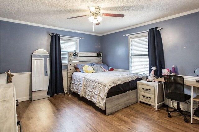 265 Traders Hill Rd, Folkston, GA 31537 - bedroom featuring crown molding, a textured ceiling, wood finished floors, and a ceiling fan