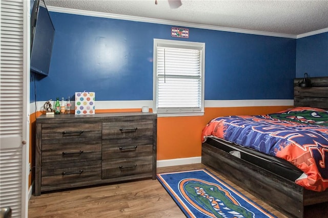 265 Traders Hill Rd, Folkston, GA 31537 - bedroom with ornamental molding, a textured ceiling, baseboards, and wood finished floors