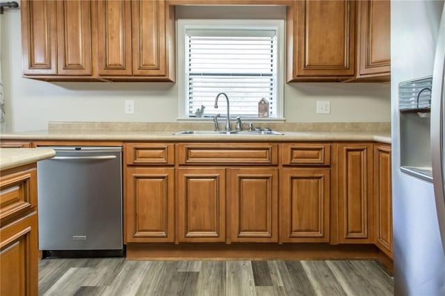 1348 Crestridge Rd, Waycross, GA 31503 - kitchen with appliances with stainless steel finishes, brown cabinets, wood finished floors, and light countertops