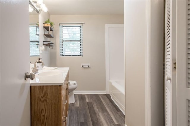 1348 Crestridge Rd, Waycross, GA 31503 - full bath featuring vanity, wood finished floors, and a tub