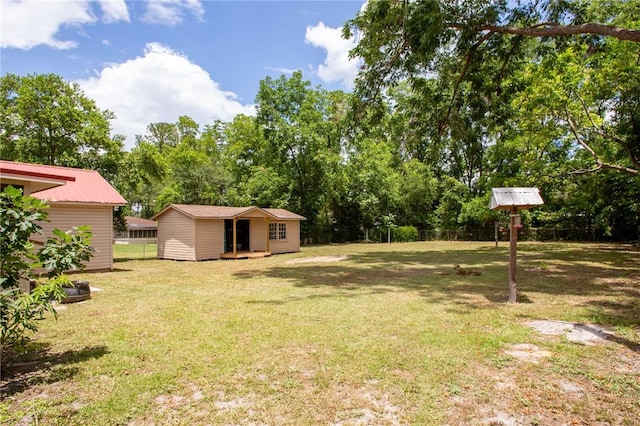 1348 Crestridge Rd, Waycross, GA 31503 - view of grassy yard featuring an outdoor structure and view of wooded area